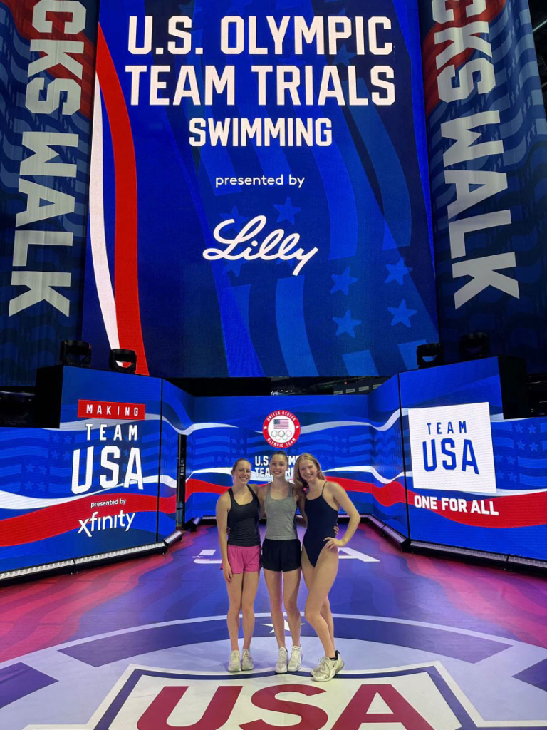 Lilla Bognar (l), and Kate Hurst join Caroline Larsen (r) in front of the swimmers' entrance at the 2024 U.S. Olympic swimming trials. Contributed photo June 2024