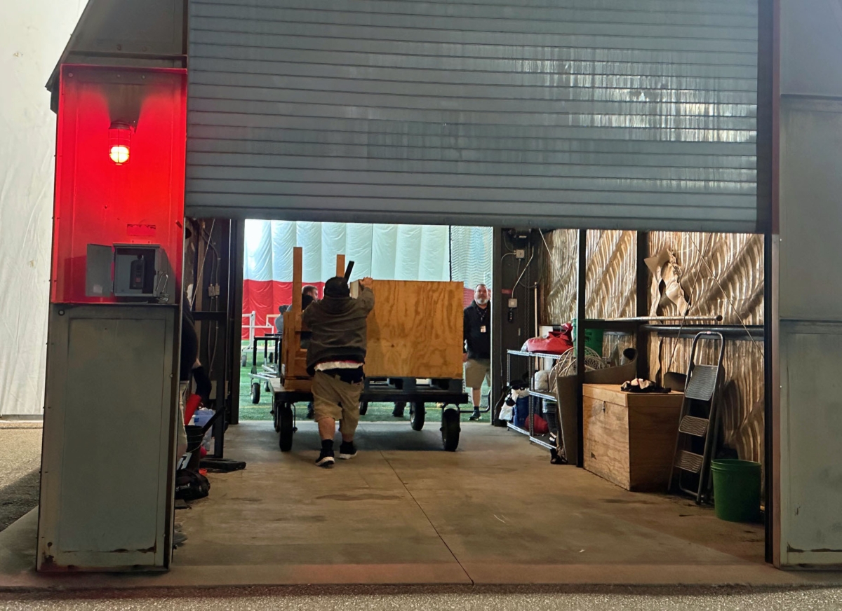 Workers pushed carts into the damaged Prairie Dome through an airlock garage as they began removing lights and other equipment Tuesday night. Photo by Jim Bayer